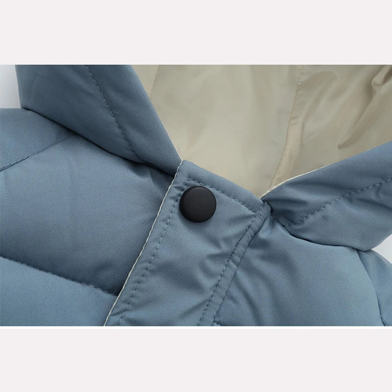 Blue puffer coat close-up with button-fastened collar and quilted panels
