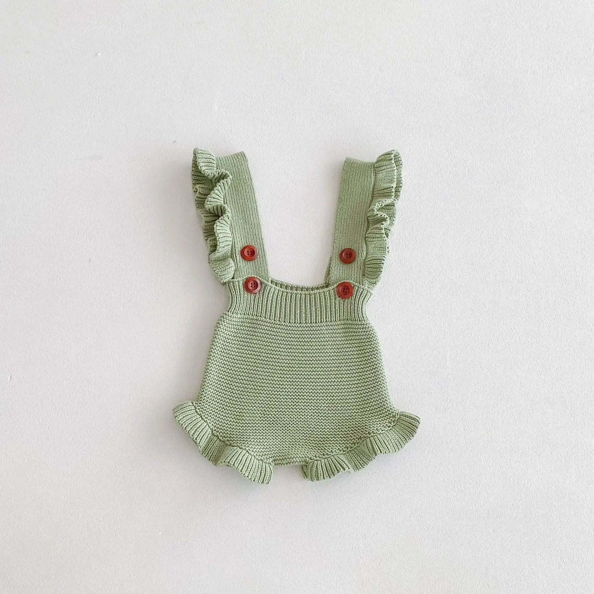 Green baby knit romper close-up with ruffled arm openings and button front