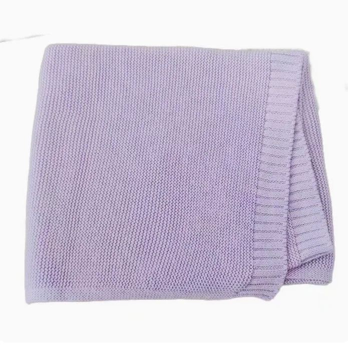 Baby knitted swaddle blanket in lavender purple with ribbed edge and trim