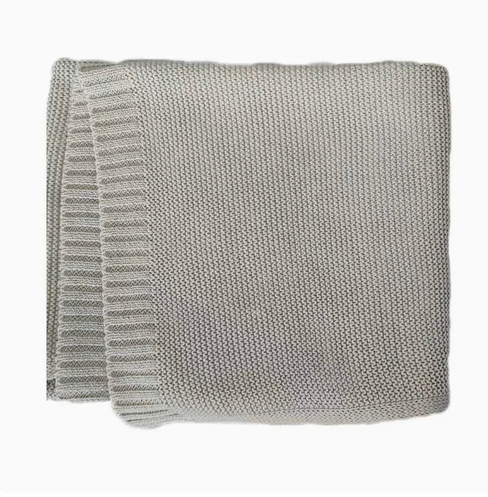 Baby knitted swaddle blanket in light gray-beige with ribbed edge trim