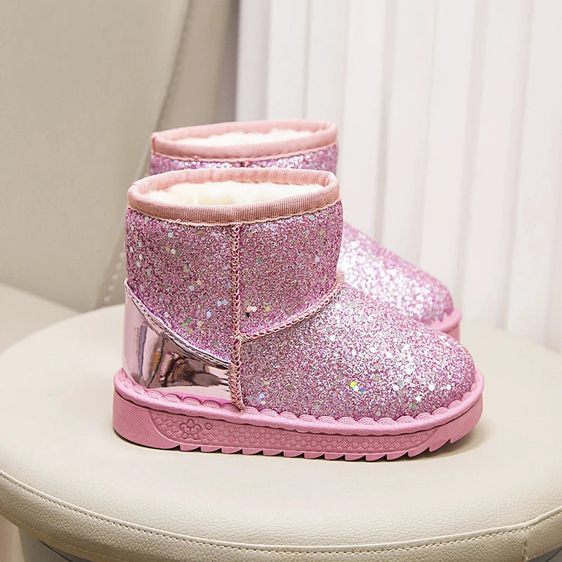 Kids pink glitter snow boots, angled view showing thick fur and tread sole
