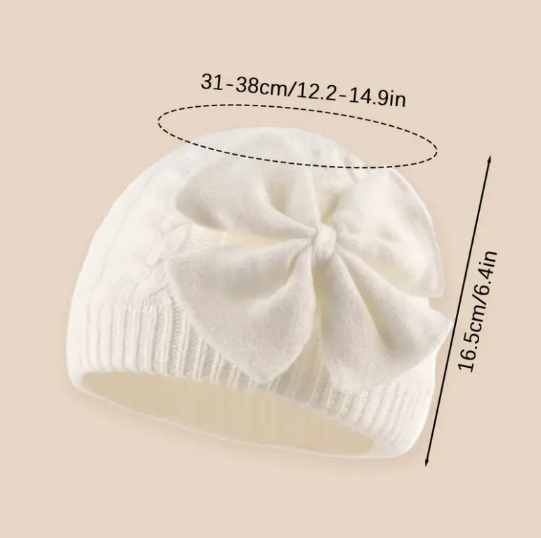 White knitted baby beanie hat with large bowknot detail
