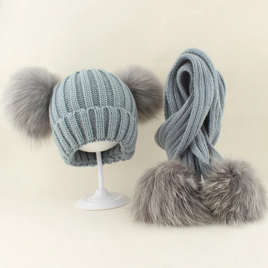 Grey knit raccoon hat with double fur pom and matching scarf with fur trim ends