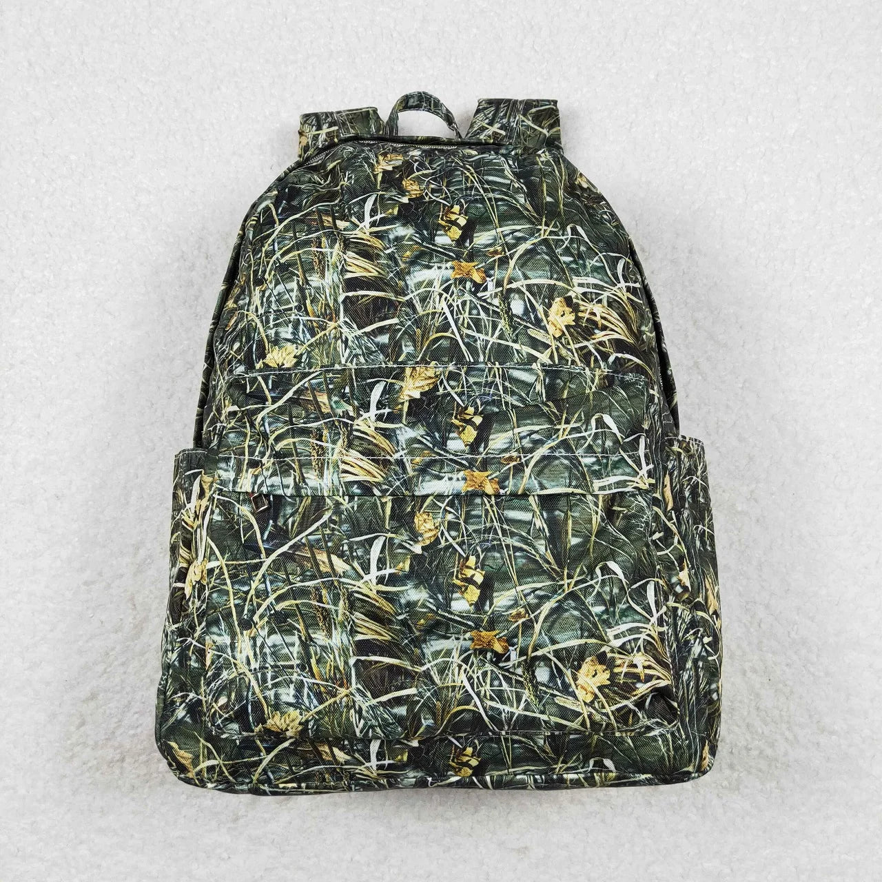 Backpack with a camouflage pattern on a light gray background
