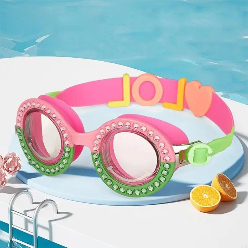 Pink goggles with LOL-style strap detail, green beaded rims, and clear lenses