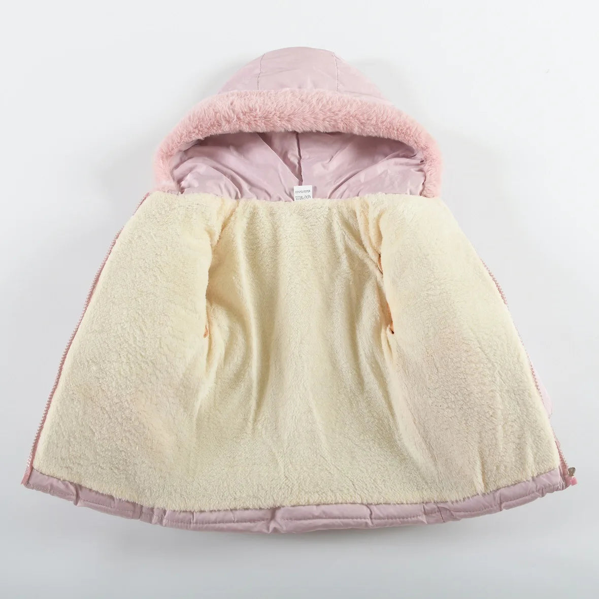Baby cape with pink hood and yellow body on a light gray background