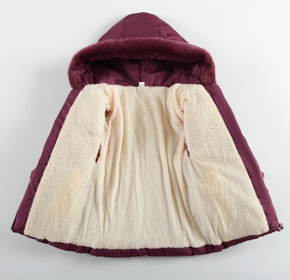 A hooded puffer jacket shown flat against a light gray background, featuring a deep plum purple exterior, a plush cream-colored fleece lining, and a matching faux-fur trimmed hood.