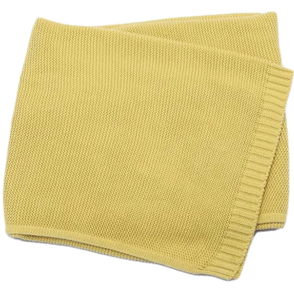 Baby knitted swaddle blanket in mustard yellow with ribbed edge border