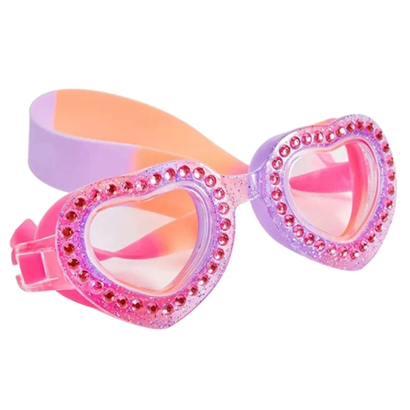 Pink and lilac swimming goggles with heart-shaped diamante details, anti-fog lenses, UV protection, and an adjustable strap for a secure and comfortable fit.