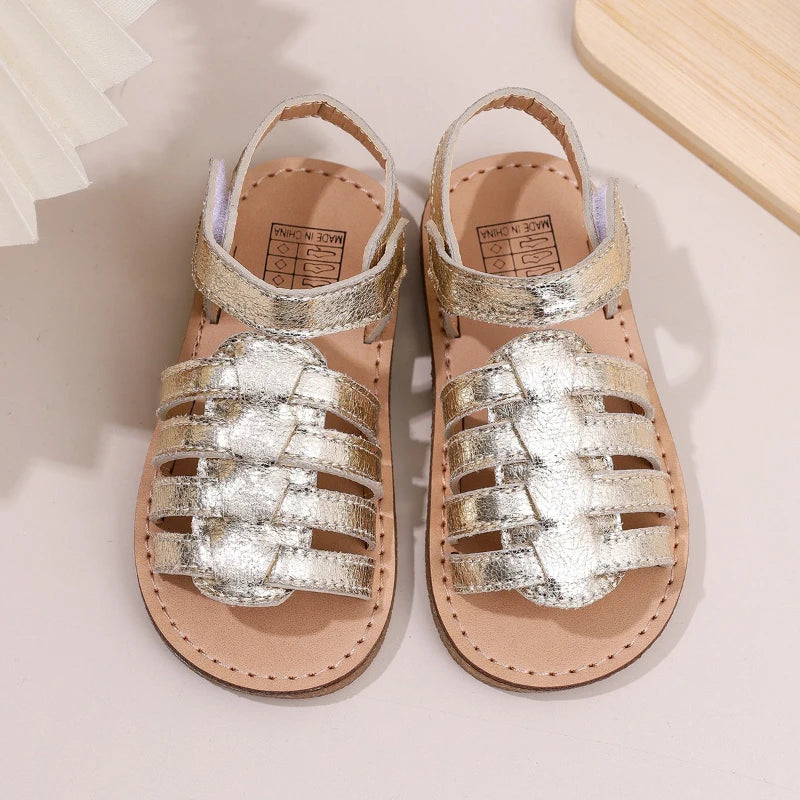 Girls gold metallic sandals with adjustable straps and hook-and-loop closure, flat sole pair