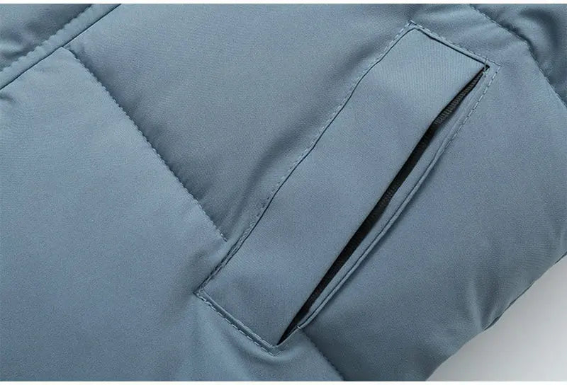 Kids blue puffer parka sleeve and pocket flap close-up with stitched seams