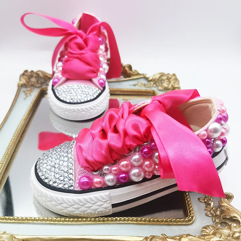 Fuchsia canvas pump with rhinestone toe cap, pearl bead embellishment, satin bow