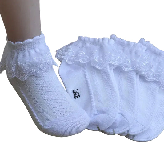 White socks with lace trim on a wooden surface