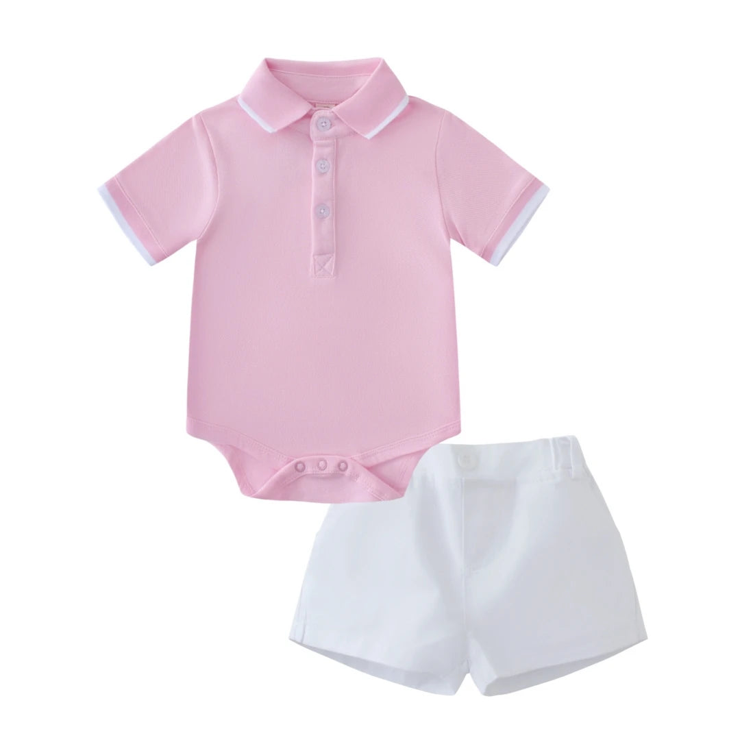 Pink baby bodysuit with white trim and matching shorts on a white background