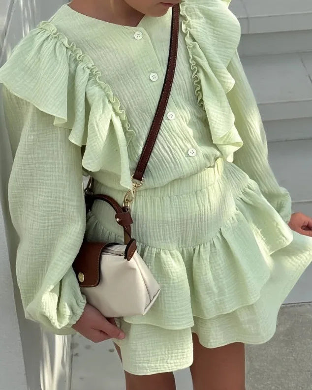 Mint green ruffle smock shirt and tiered skirt set, close-up of button front