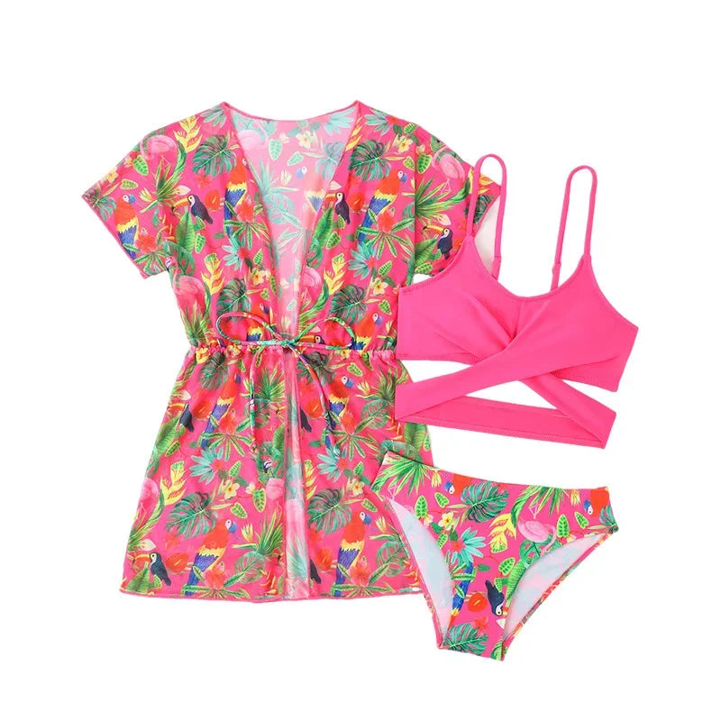 Colorful tropical-themed swimsuit set with a dress and two-piece set on a white background