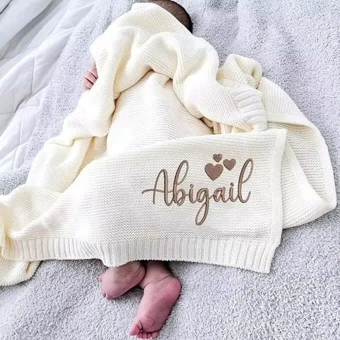 Personalized newborn knit blanket with embroidered name Abigail on cream