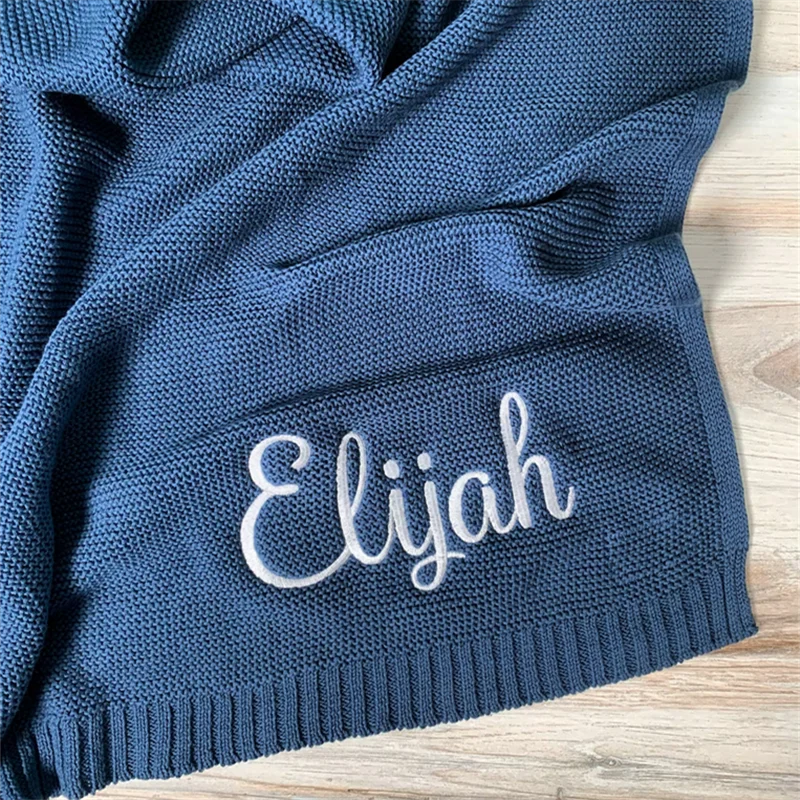 Personalized knit baby blanket with embroidered name Elijah on blue