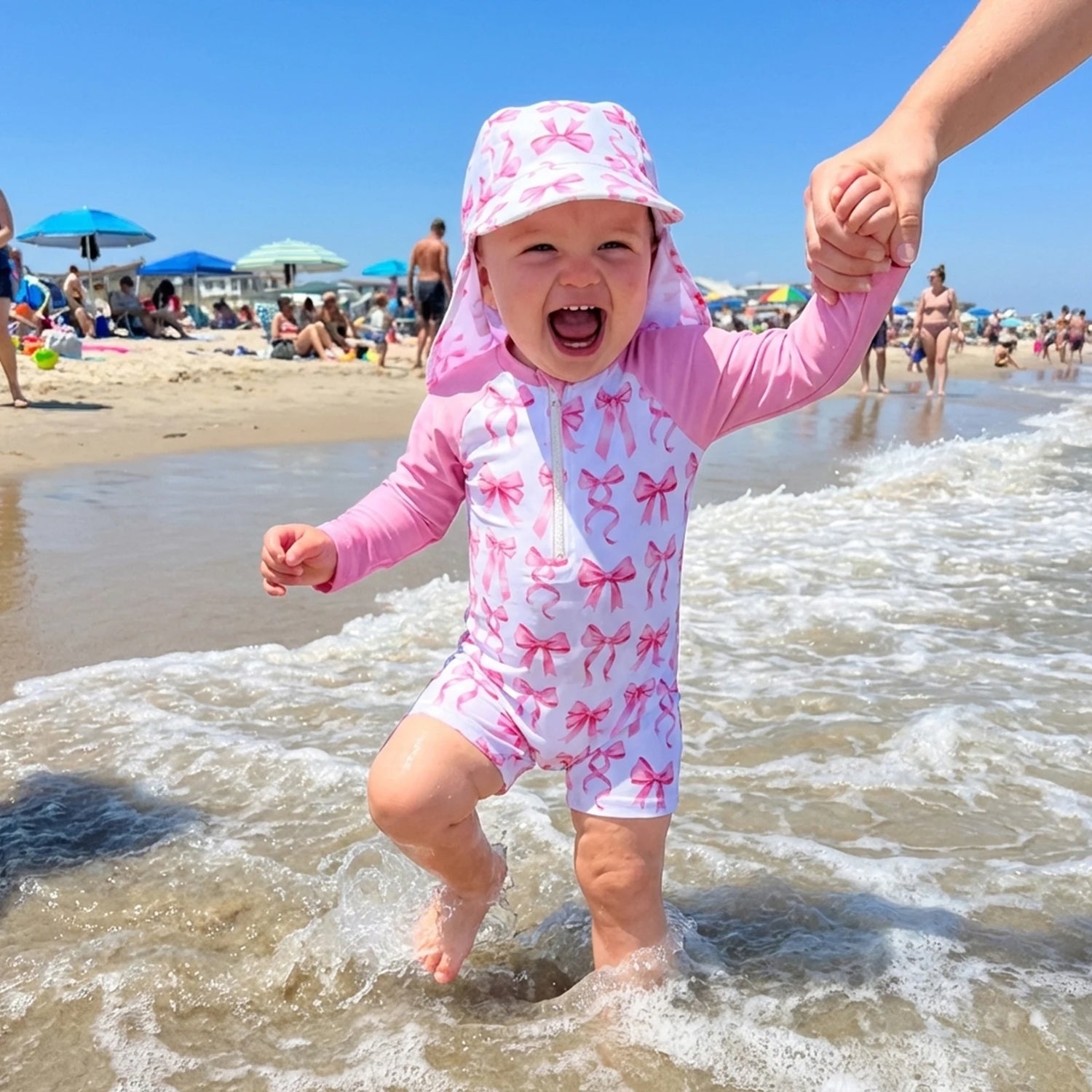 Girls pink bow print long-sleeve swim romper with matching sun hat