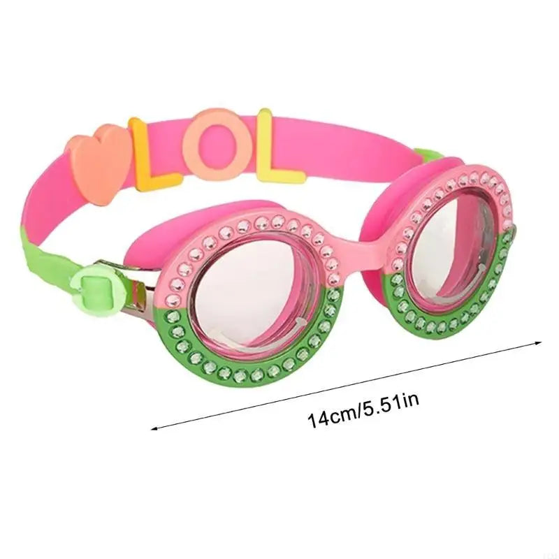 Girls pink swimming goggles with green beaded edge, heart strap, and LOL-style logo