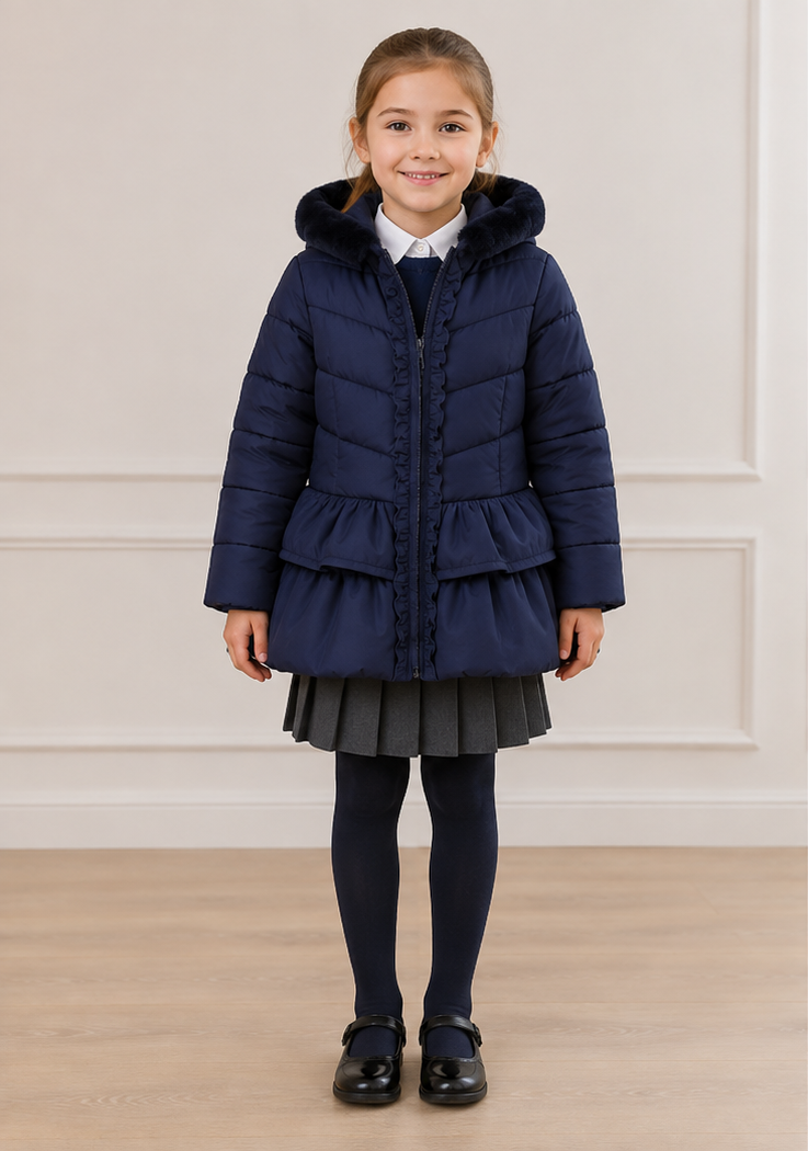 A young girl modeling a navy blue quilted winter coat, shown from both the front and back views against a neutral indoor wall and wood floor.