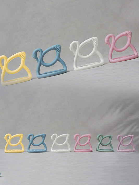 Blue swan teether among pastel colors, ridged gripping edge