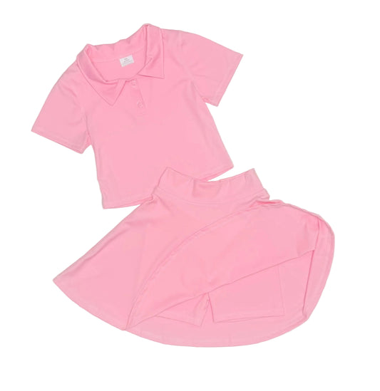 Pink outfit with top and skirt on a light gray background