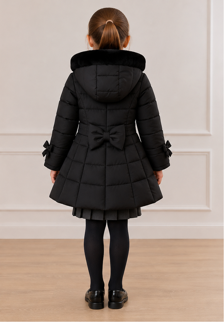 A young girl modeling a black quilted winter coat, shown from both the front and back views against a neutral indoor wall and wood floor.