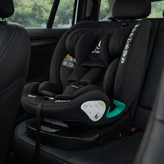 Midnight black ISOFIX car seat with padded headrest, harness pads, and green guides