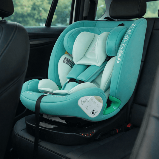 Teal car seat with newborn insert and side wings, installed on a vehicle seat
