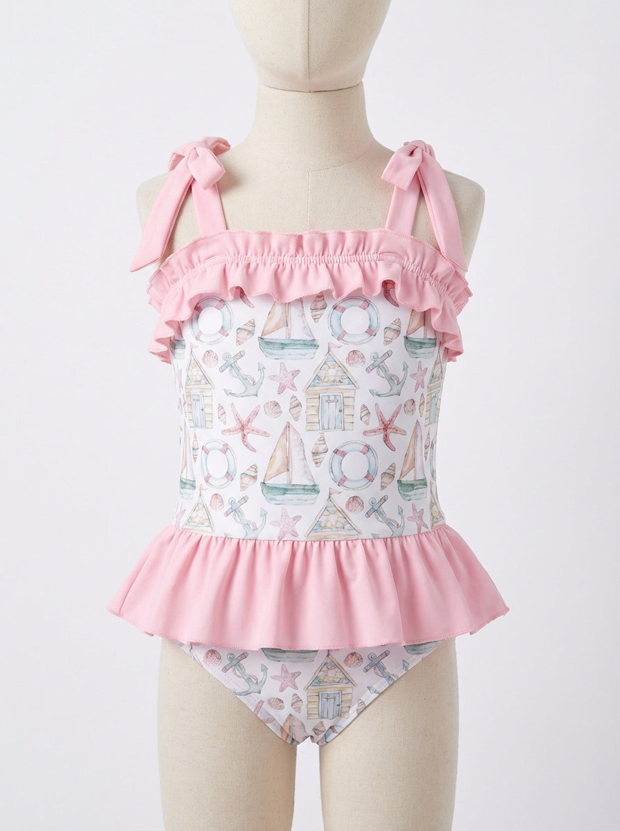 Ruffled girls one-piece swim suit with pink bow straps and star/anchor print
