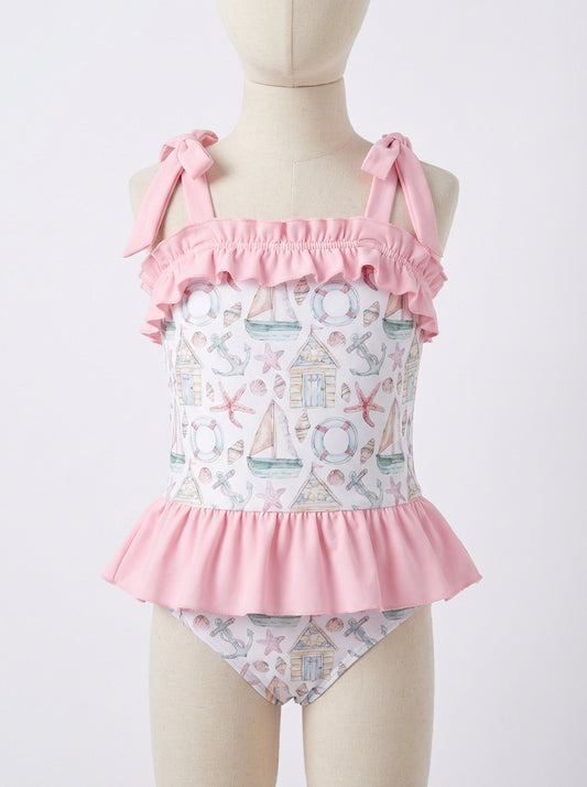Ruffled girls one-piece swim suit with pink bow straps and star/anchor print