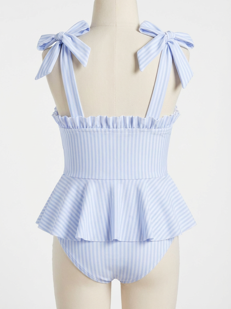 Girls light blue striped swimsuit with bow tie shoulder straps and tiered peplum skirt.