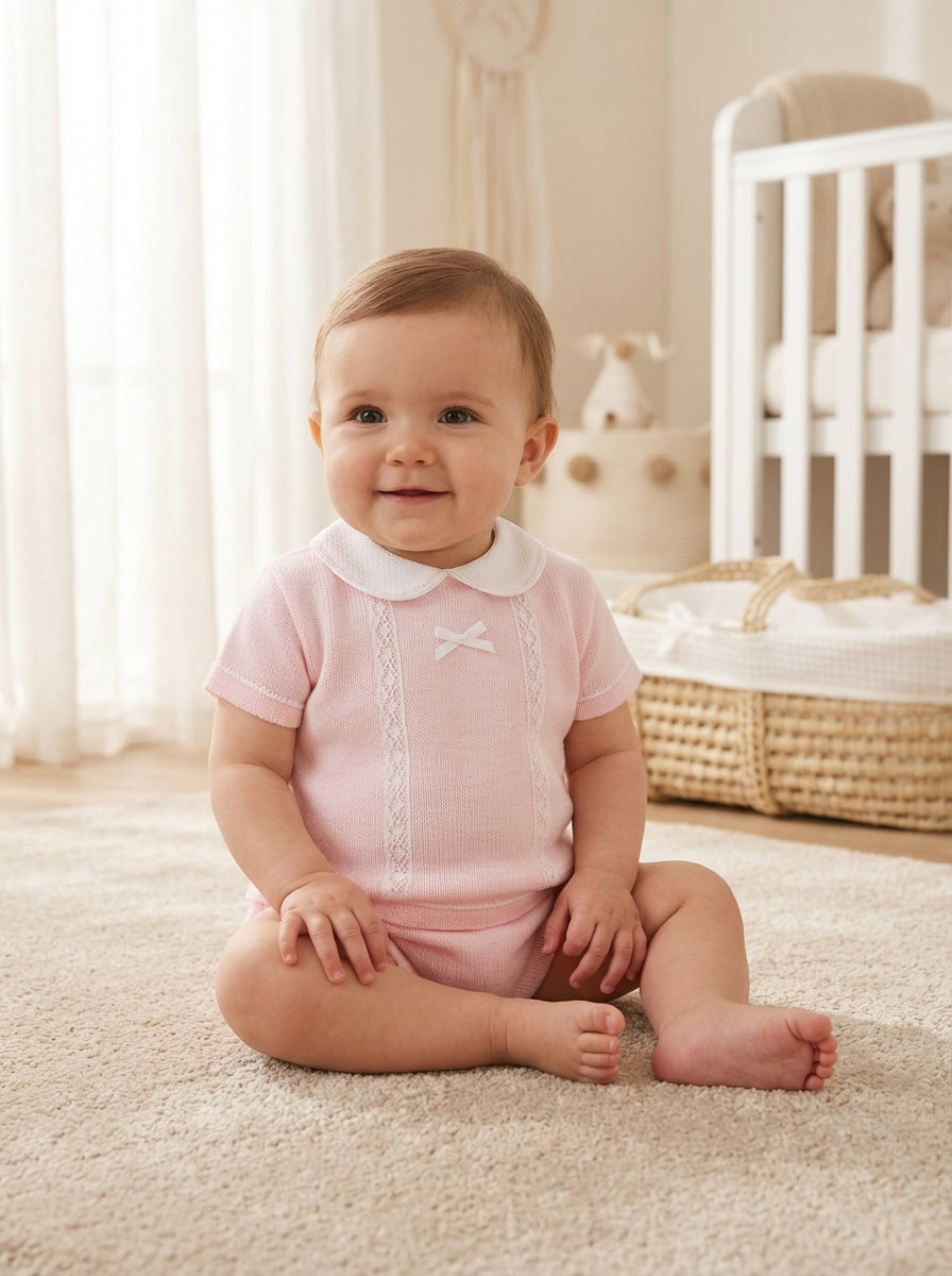 Pink girls romper outfit with white Peter Pan collar, lace panel and bow detail