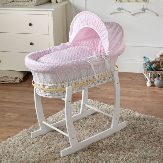 Pink dimple Moses basket on white wicker stand with canopy and pink padded bedding