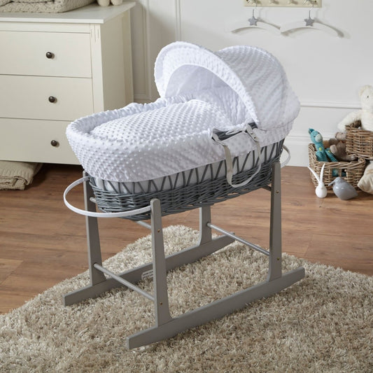 Grey wicker Moses basket with stand, white padded bedding and curved hood