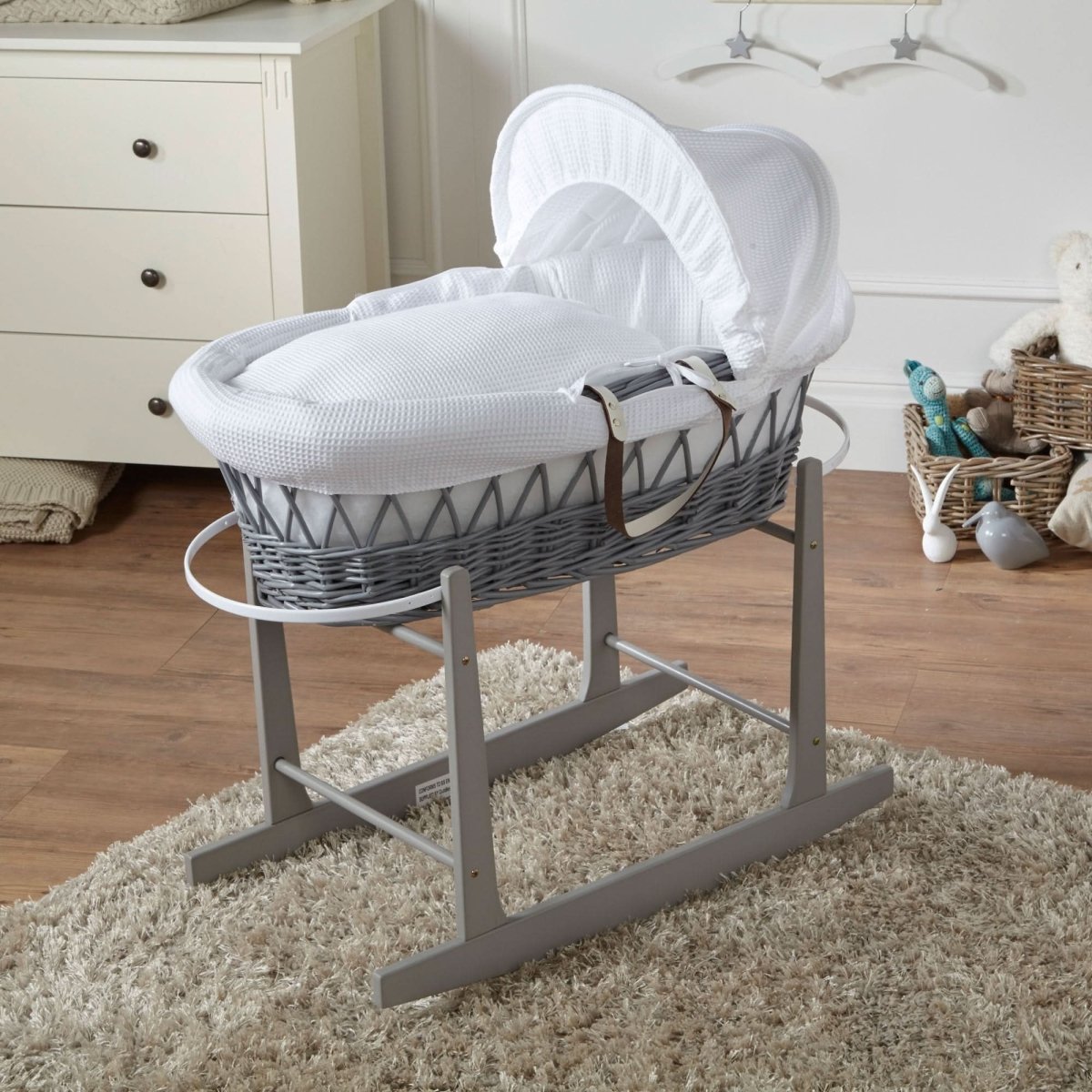 White waffle Moses basket with grey wicker rocking stand and white hood