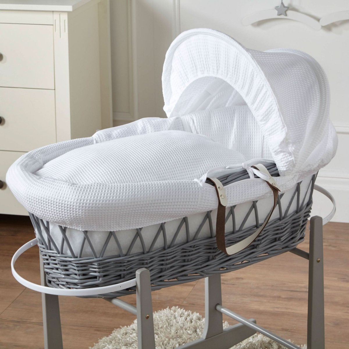 White Moses basket with grey wicker and white hooded mattress on rocking stand