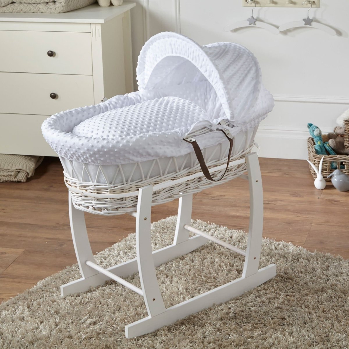 White wicker Moses basket on stand with light grey textured mattress cover and hood