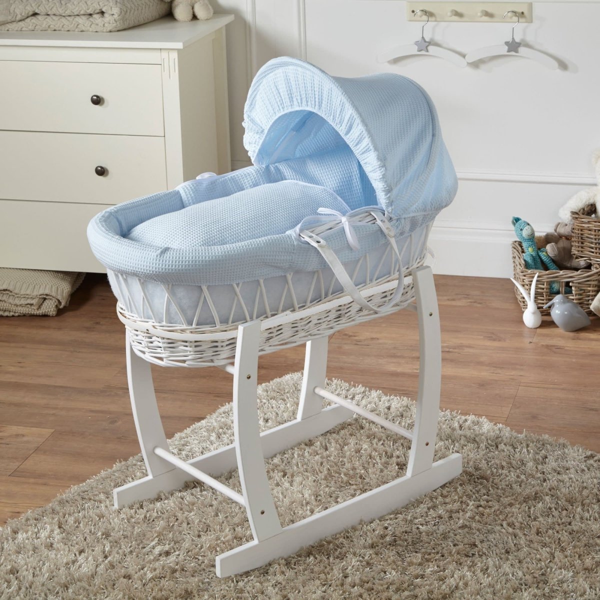 Wicker baby Moses basket with stand in white, blue waffle bedding with hood and ties