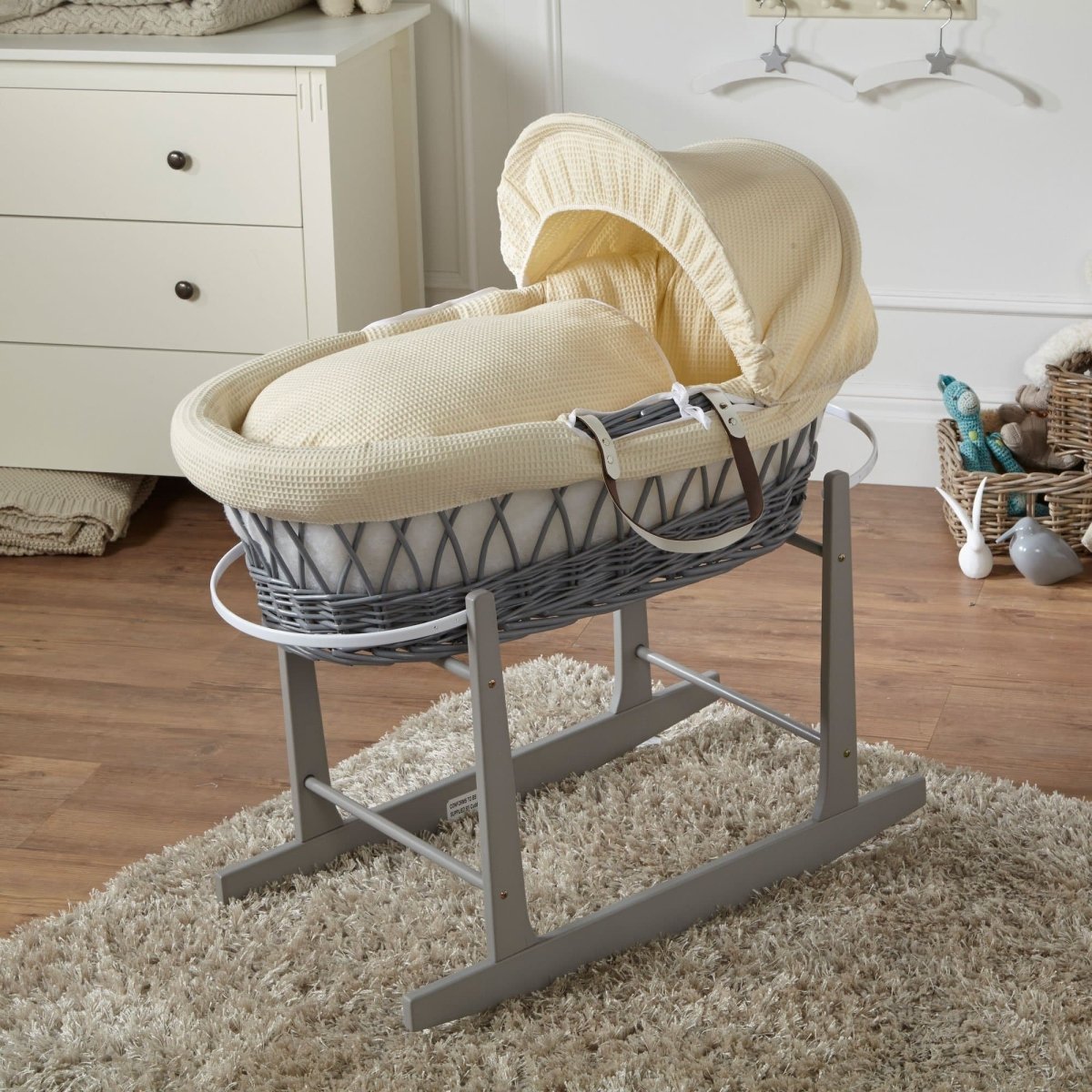 Cream Moses basket on stand with cream textured bedding and curved fabric hood