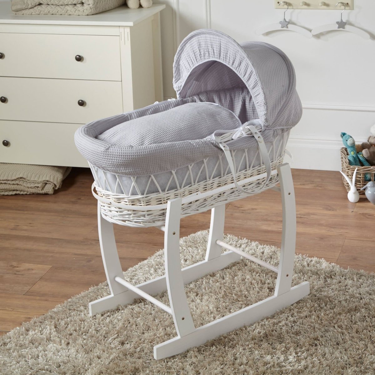 Wicker baby Moses basket with stand in white, grey waffle bedding with raised hood