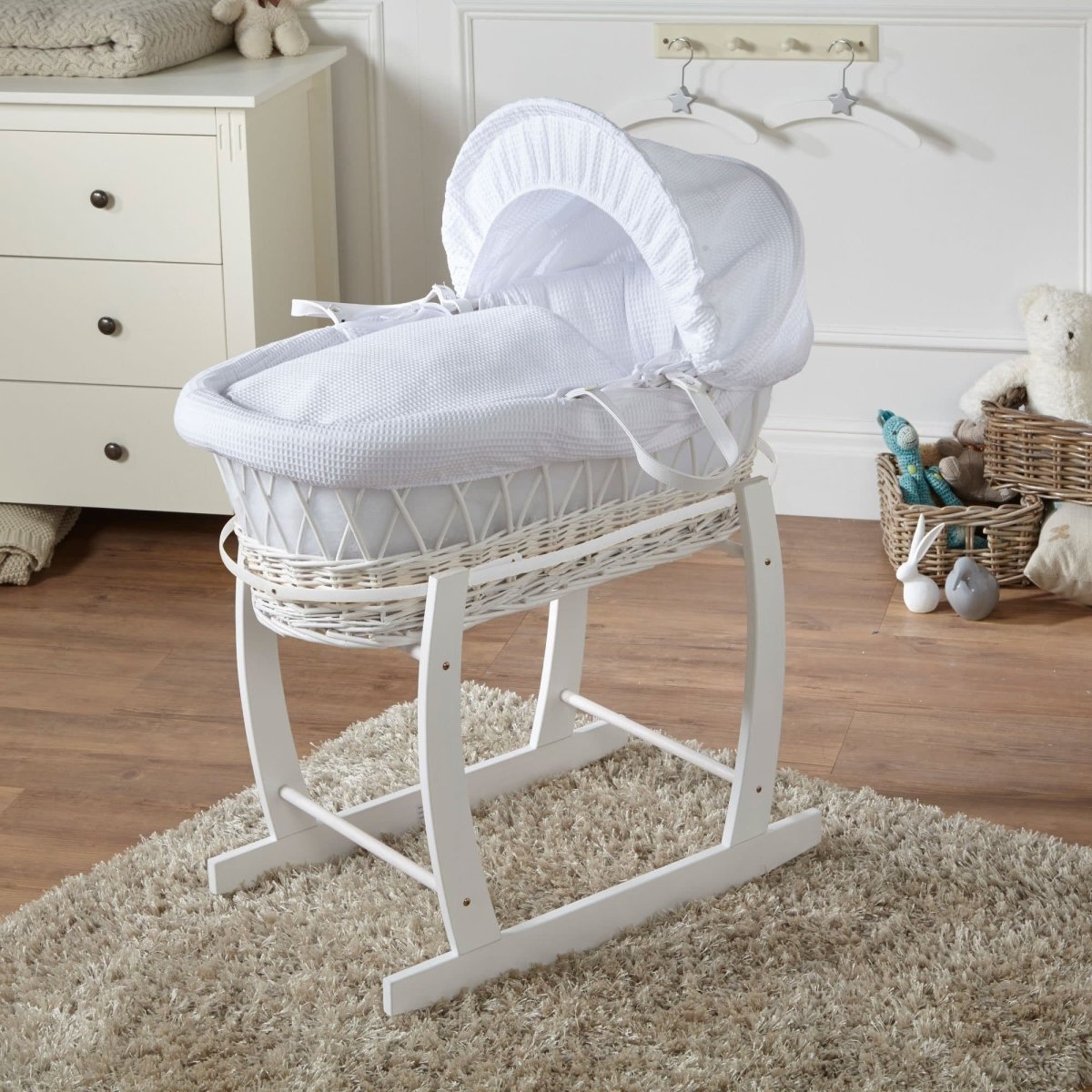 Wicker baby Moses basket with stand in white, white bedding with hood and side ties