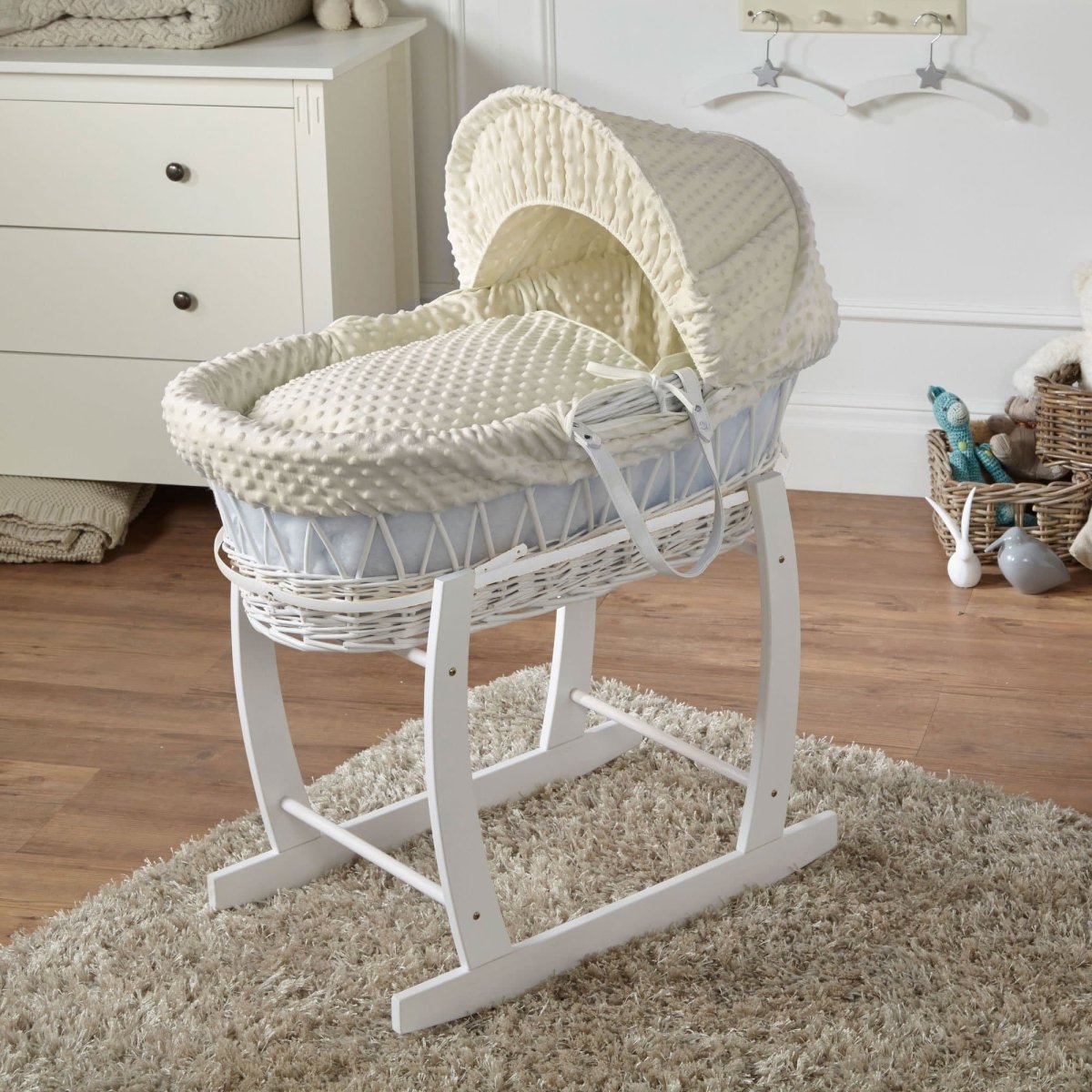 White wicker Moses basket on stand with white textured mattress cover and hood