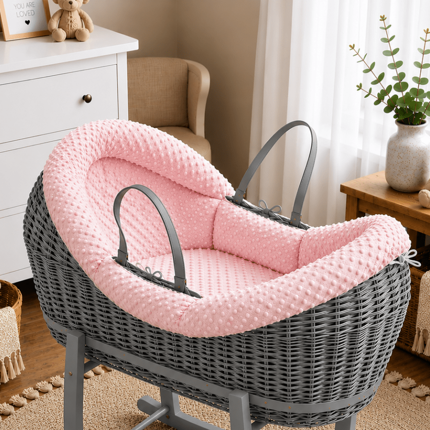 Pink wicker moses basket with pink padded waffle liner and carrying handles