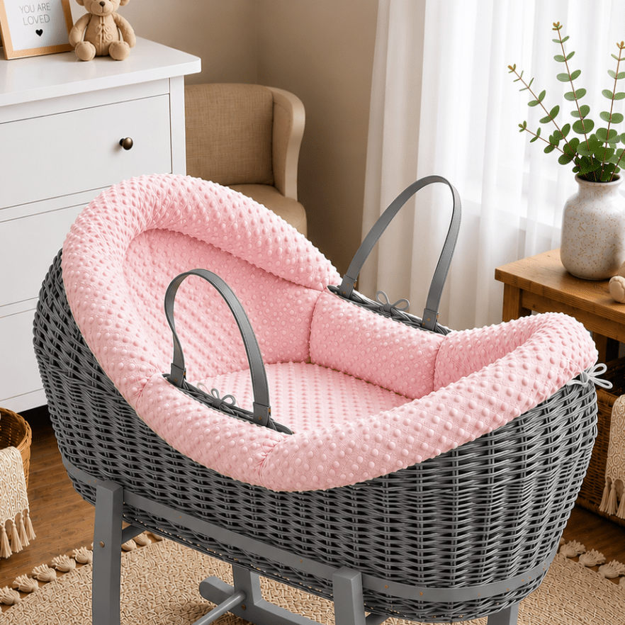 Wicker moses basket with pink textured carrycot insert and dark-gray handle straps