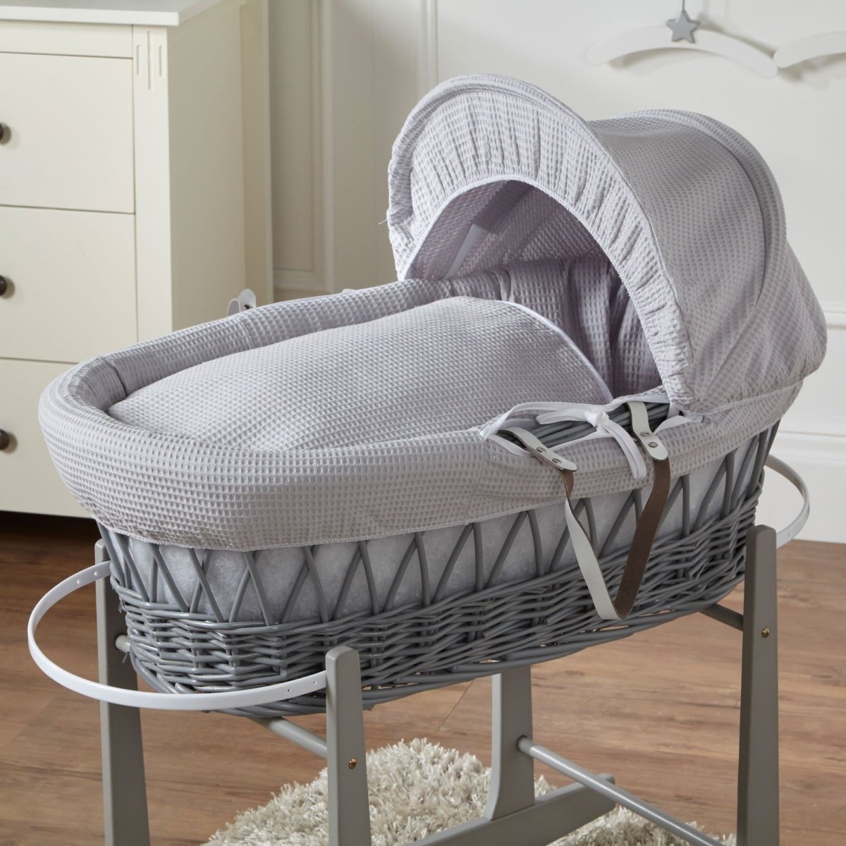 Wicker Moses basket with grey cover and white waffle bedding, no stand