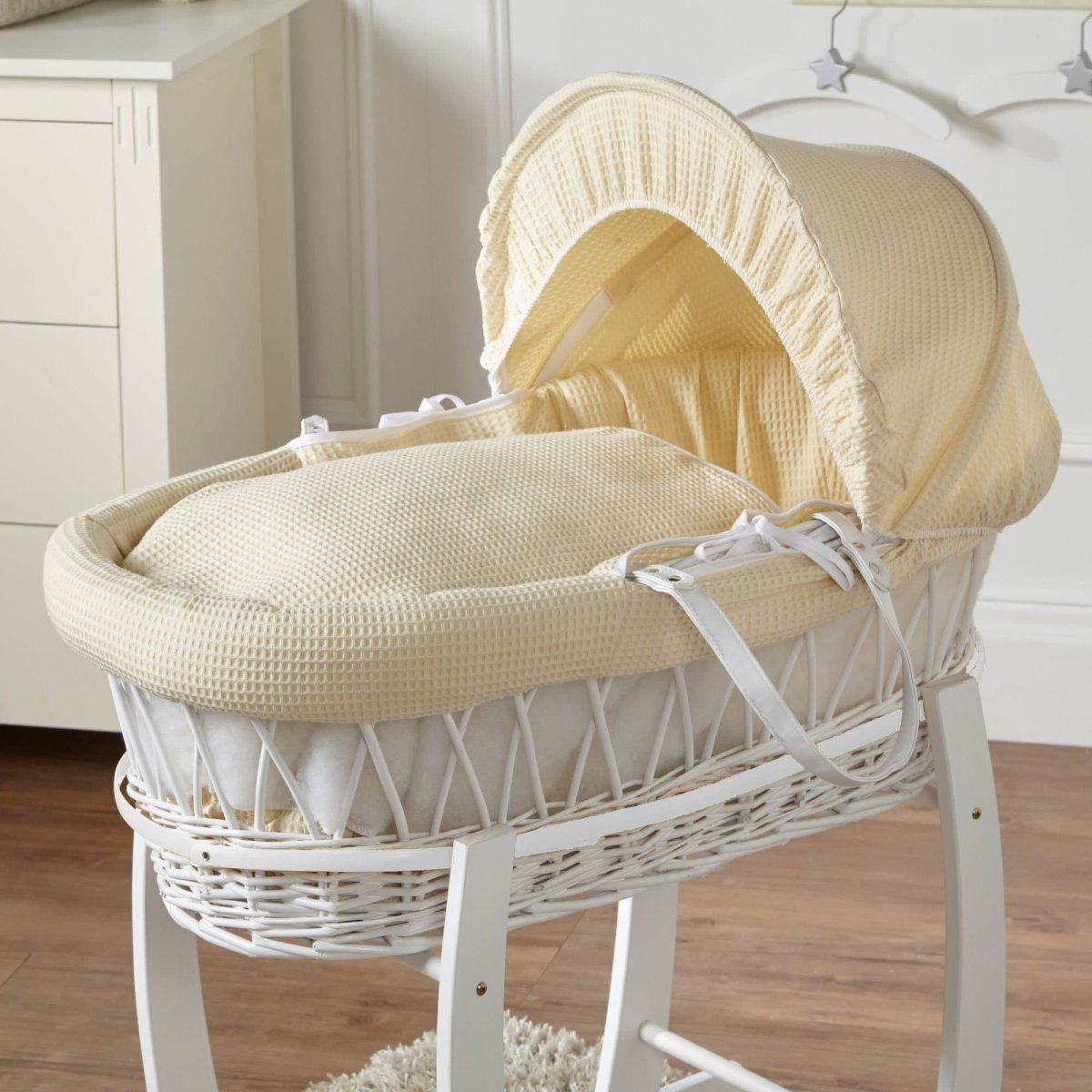 Cream Moses basket with waffle bedding, hood up and leather-look handle straps