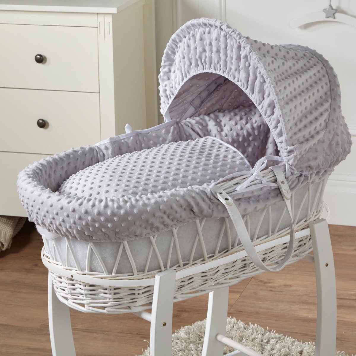 Grey Moses basket with textured waffle bedding and padded adjustable hood