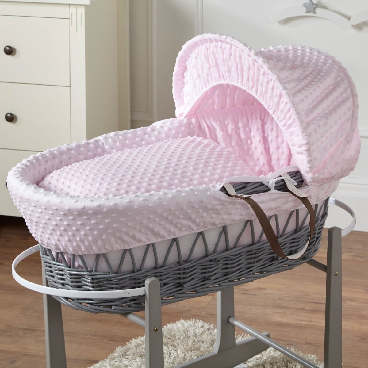 Wicker Moses basket with pale pink quilted bedding and matching hood cover